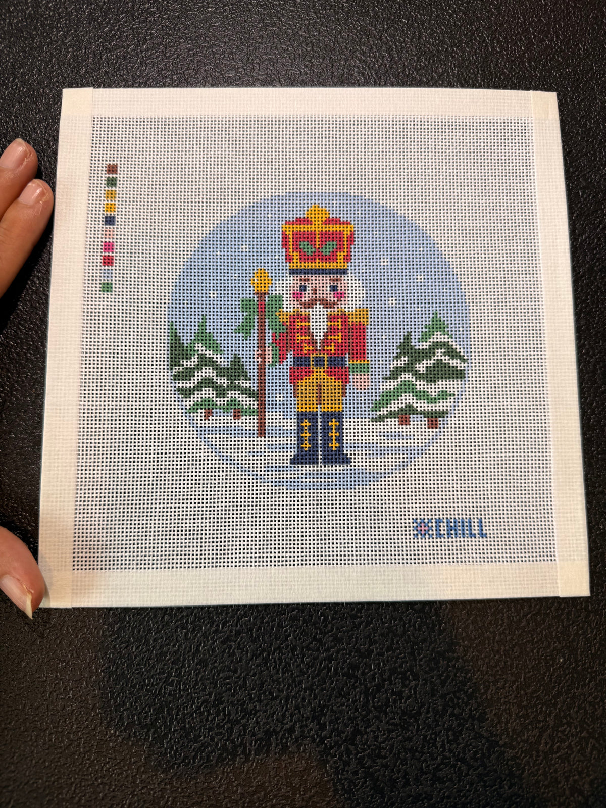 Taped edges on the 8x8 nutcracker needlepoint canvas, ready to stitch