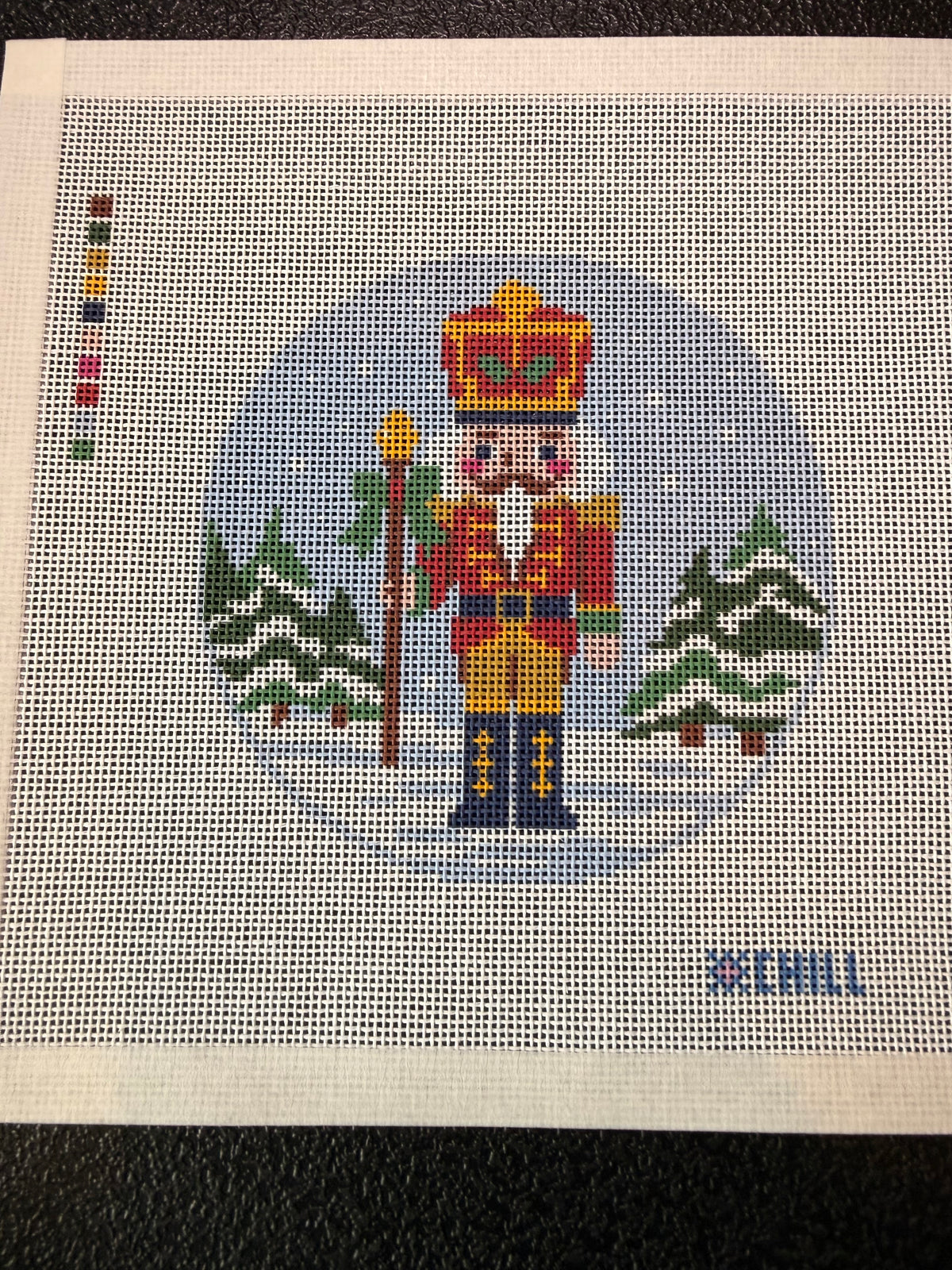 Angled view of the round nutcracker ornament needlepoint canvas